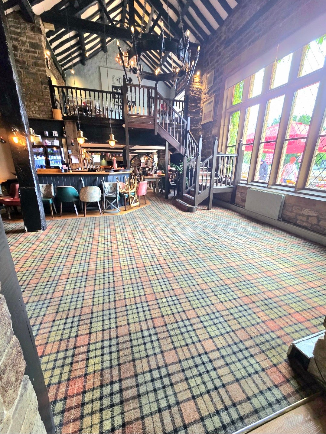 Main bar area at The Stansfield Arms showing cleaned tartan carpet throughout the pub