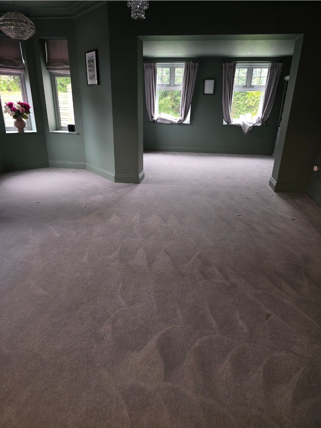 Large living room with grey carpet and green walls after professional cleaning in Harrogate