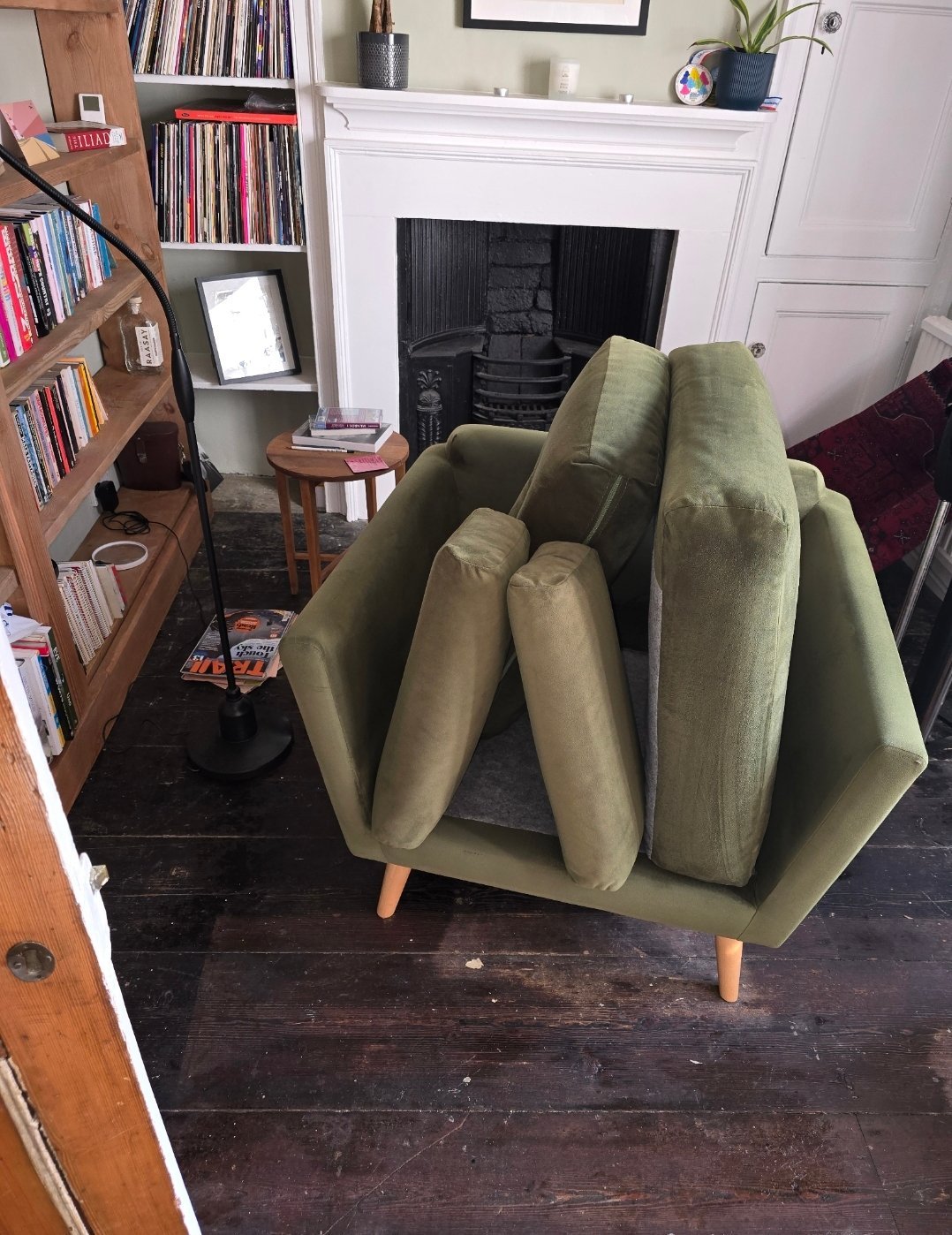Green velvet sofa with cushions removed for upholstery cleaning in an Ilkley cottage