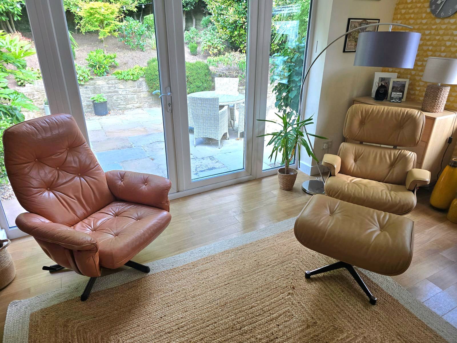 Two leather armchairs in a bright sunroom after cleaning and conditioning
