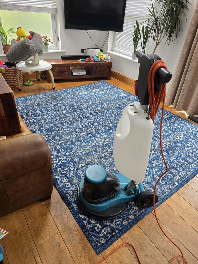 Professional carpet cleaning buffer machine on a rug in an Otley home